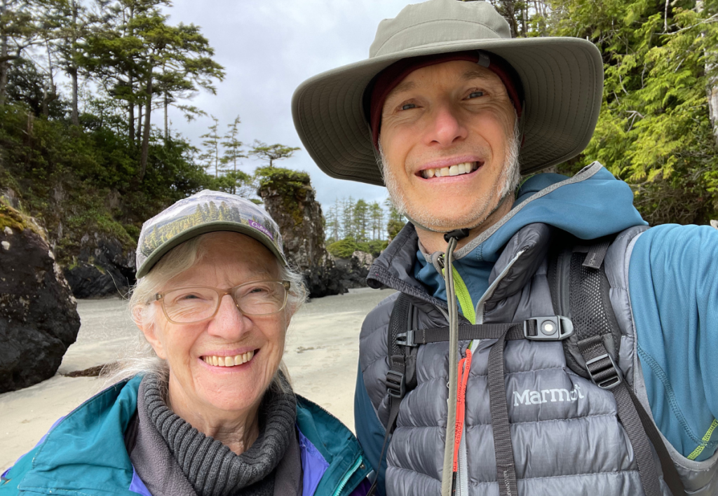 Arne Pedersen and his mother sharing a peaceful moment at San Joseph Bay, a beautiful beach on Vancouver Island symbolizing connection and emotional healing.