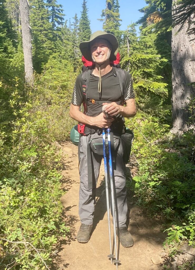 Arne Pedersen hiking in a peaceful forest, representing grounding, inner balance, confidence, and positive energy protection.